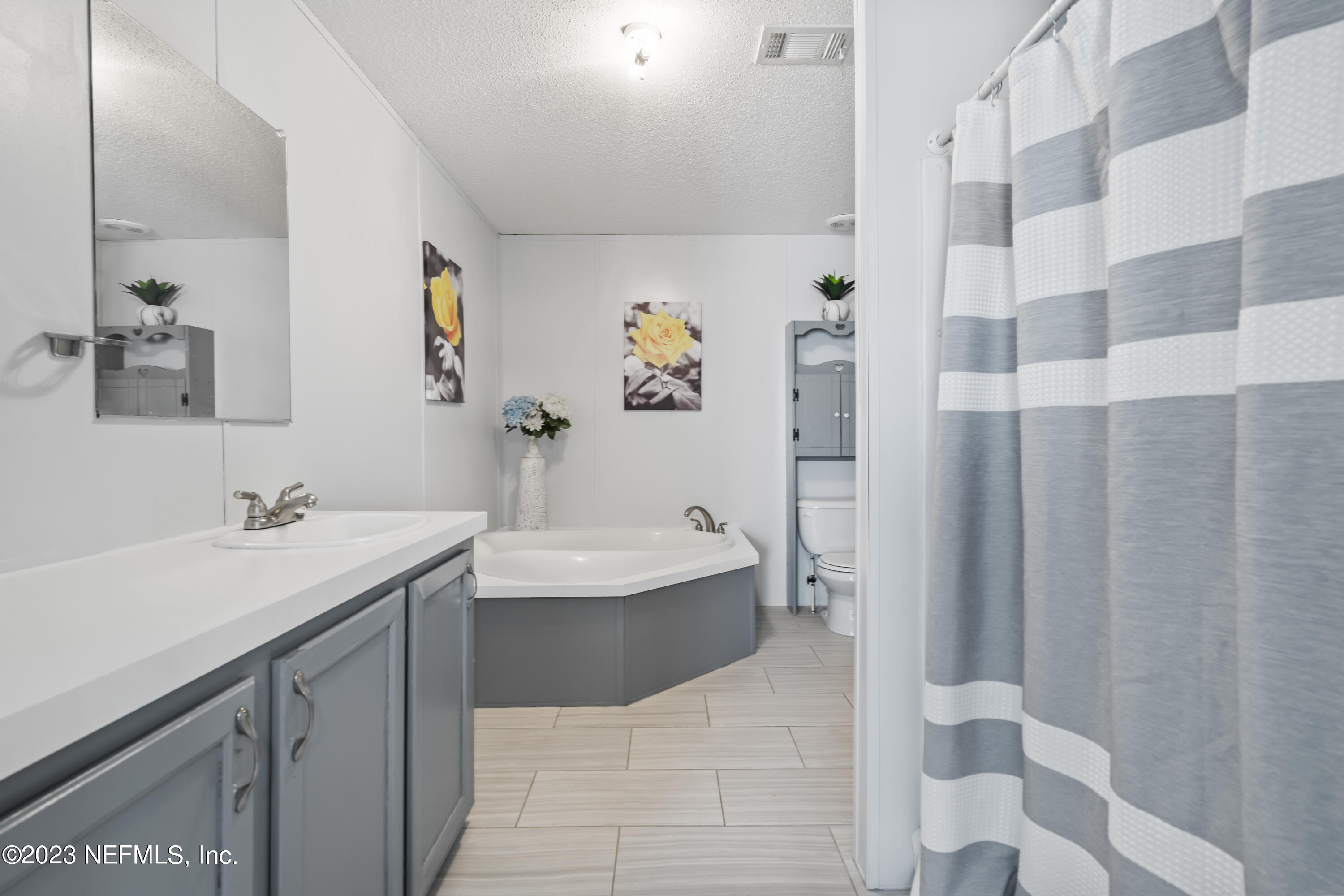 198 Yellow Water Road Baldwin, FL 32234 - Photo 24 of 37 a spacious bathroom with a sink and mirror