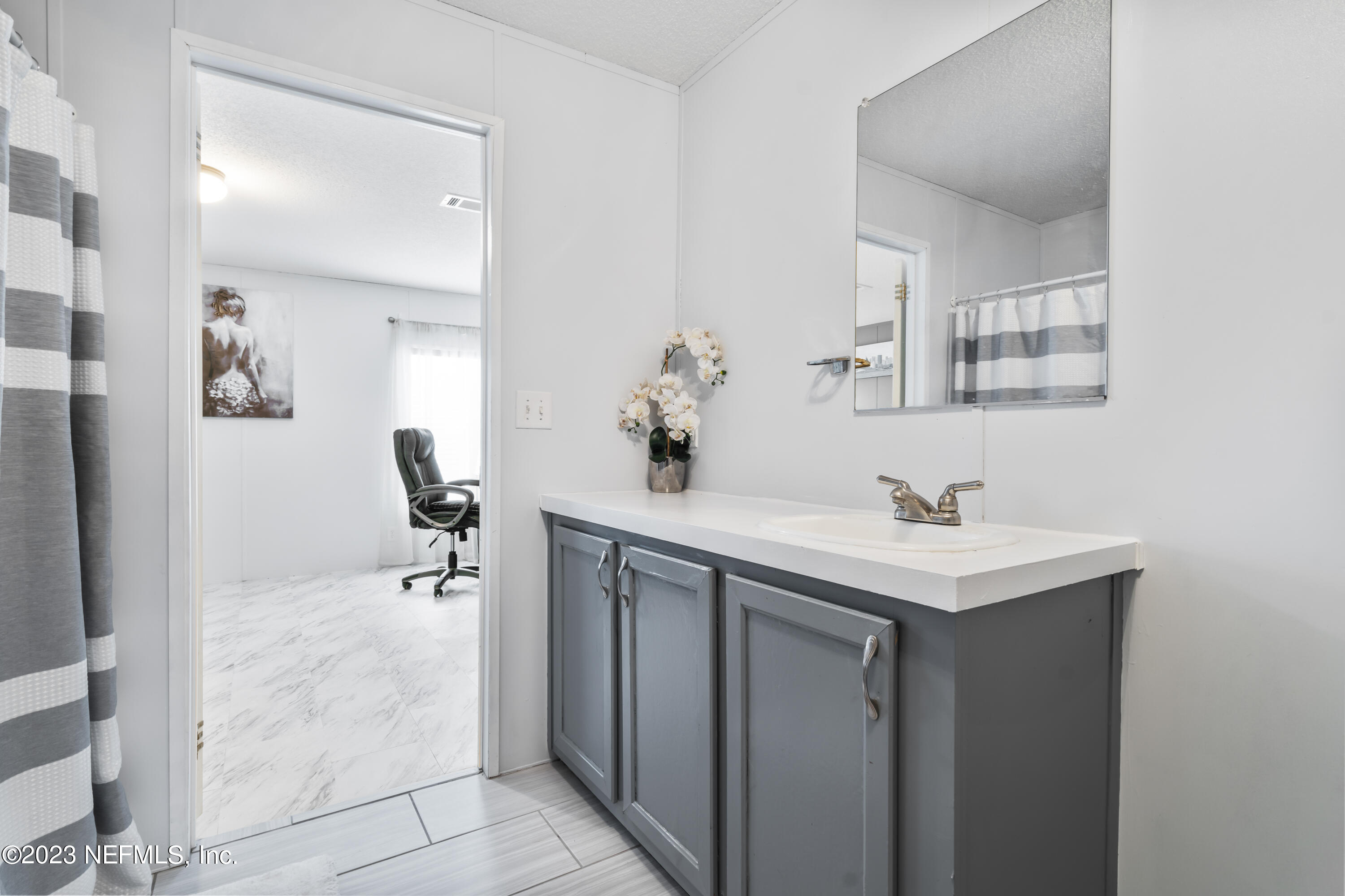 198 Yellow Water Road Baldwin, FL 32234 - Photo 26 of 37 a bathroom with a sink and a mirror