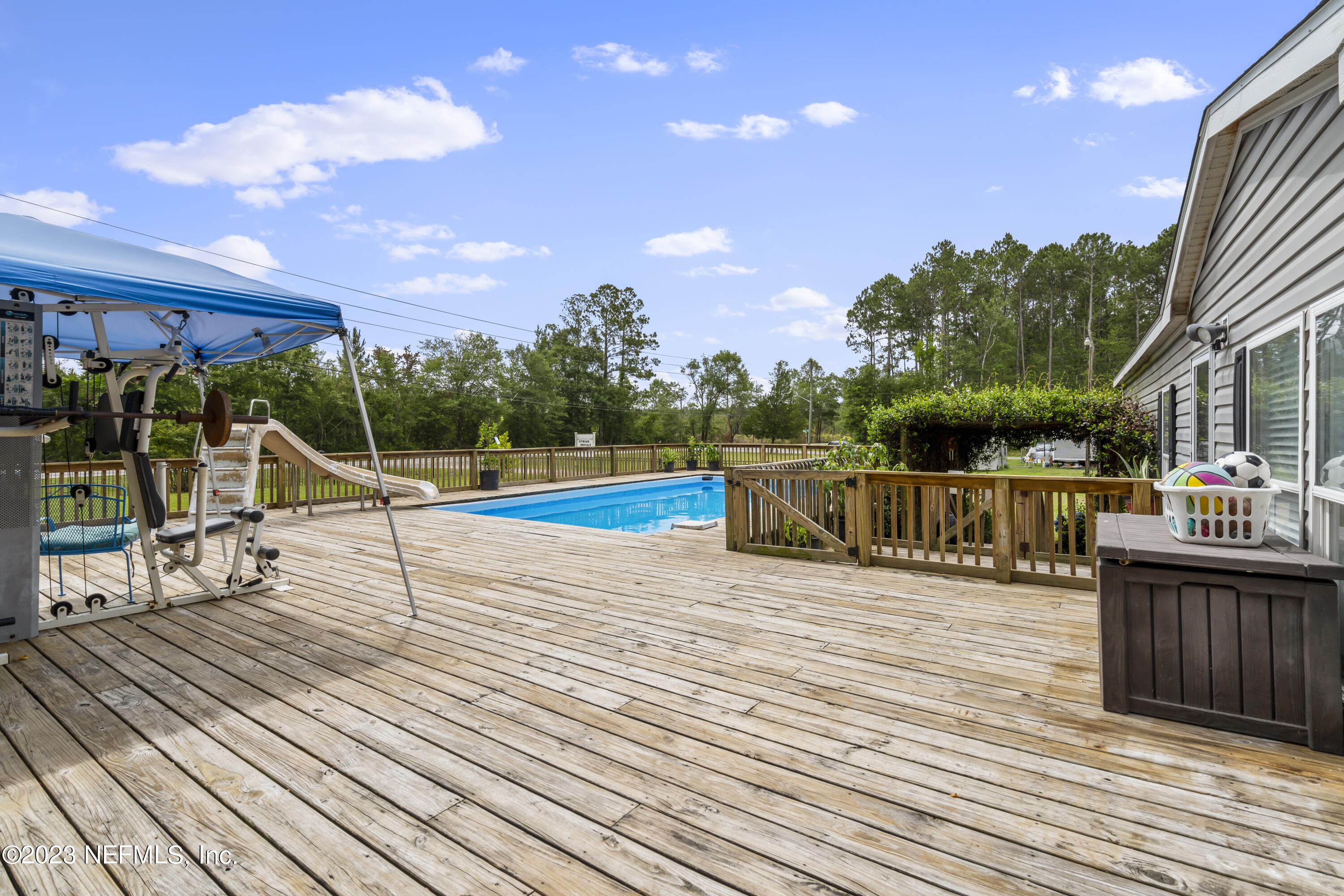 198 Yellow Water Road Baldwin, FL 32234 - Photo 32 of 37 a view of a deck with wooden floor and fence with a yard