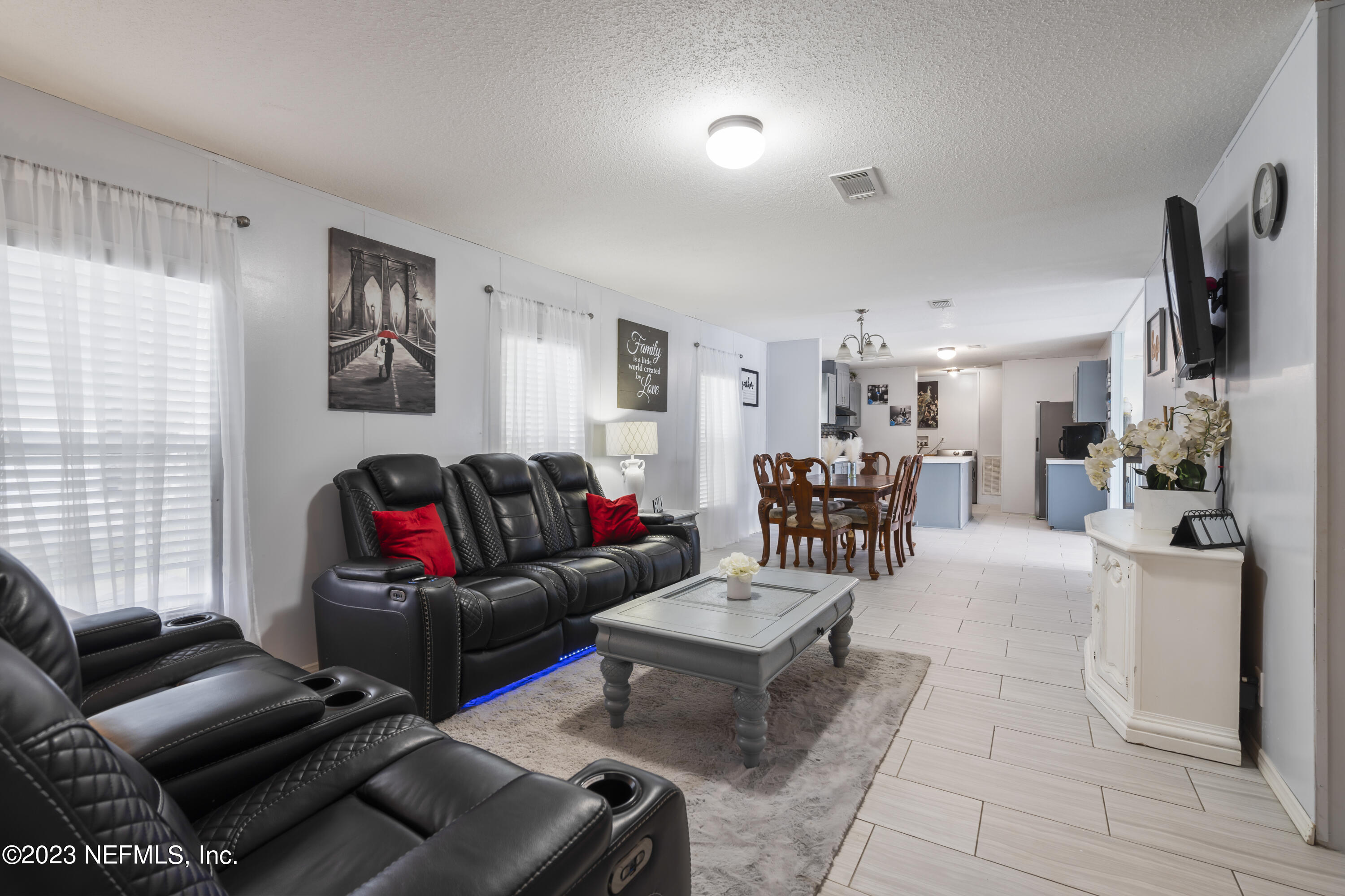 198 Yellow Water Road Baldwin, FL 32234 - Photo 6 of 37 a living room with furniture and a flat screen tv