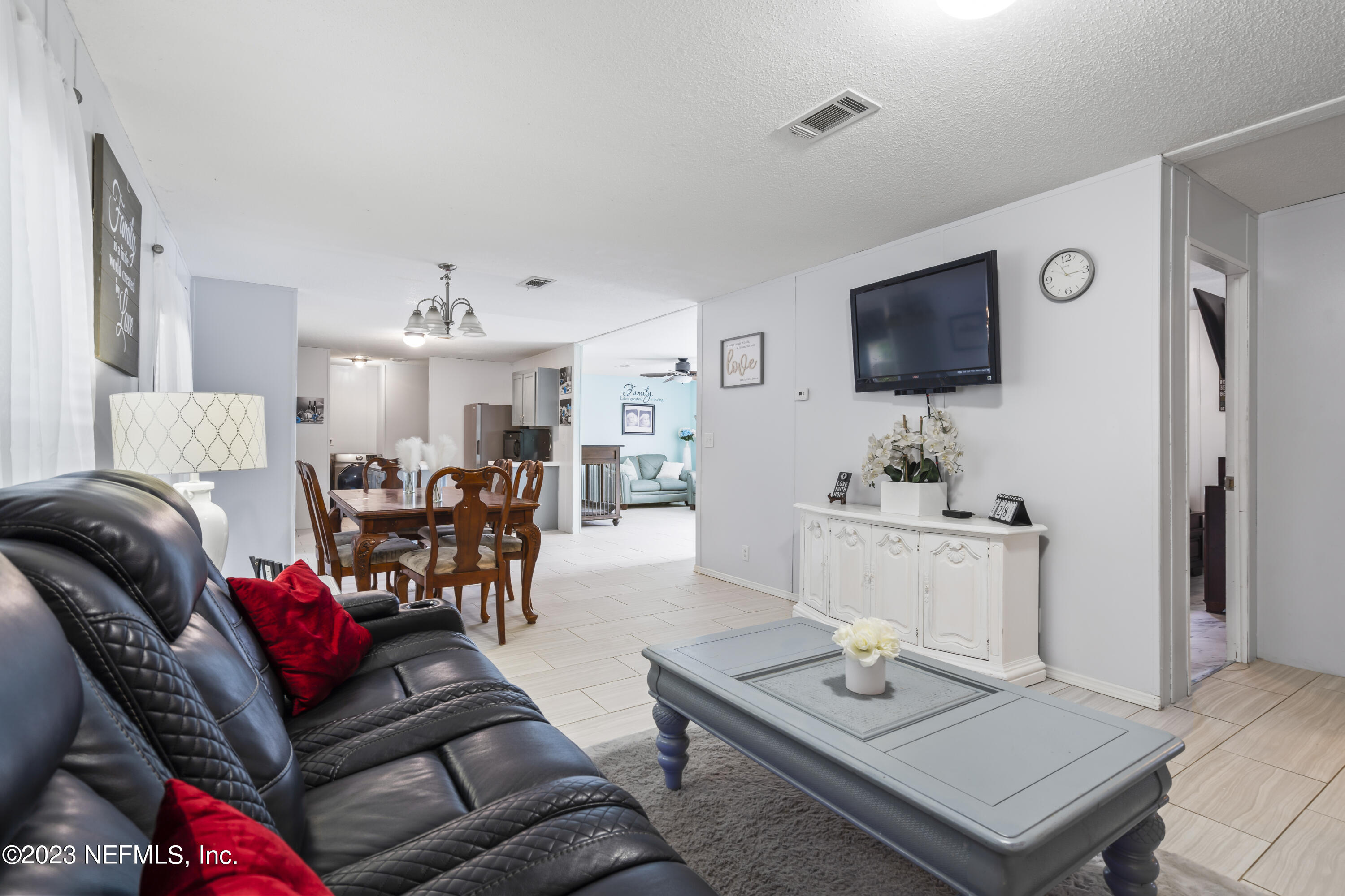 198 Yellow Water Road Baldwin, FL 32234 - Photo 9 of 37 a living room with furniture and a flat screen tv