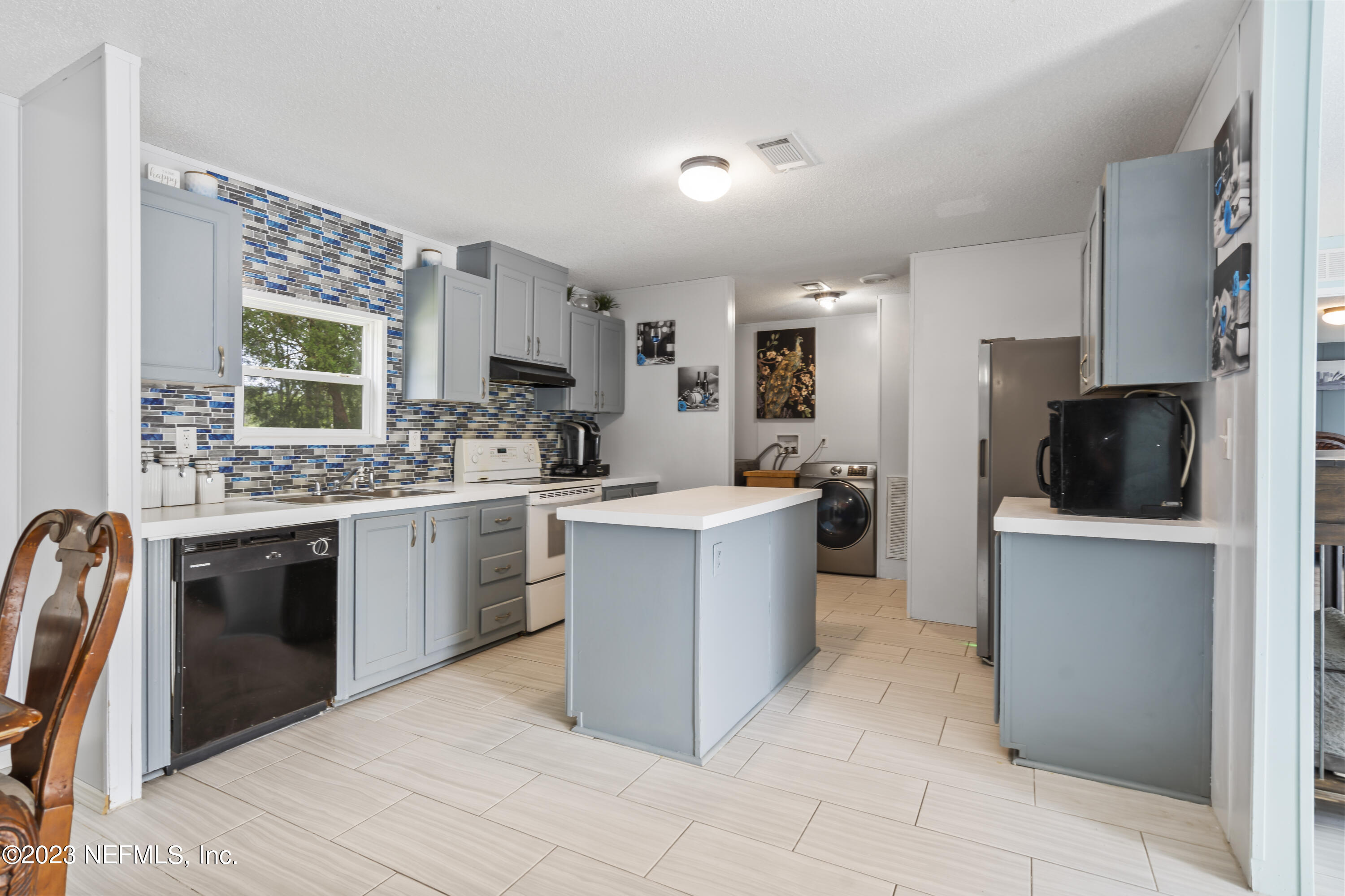 198 Yellow Water Road Baldwin, FL 32234 - Photo 10 of 37 a kitchen with a refrigerator stove top oven and sink