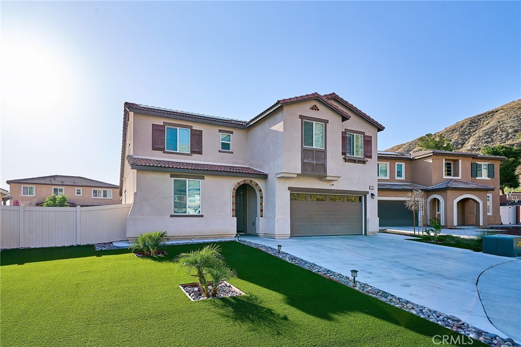 a front view of a house with a yard and garage