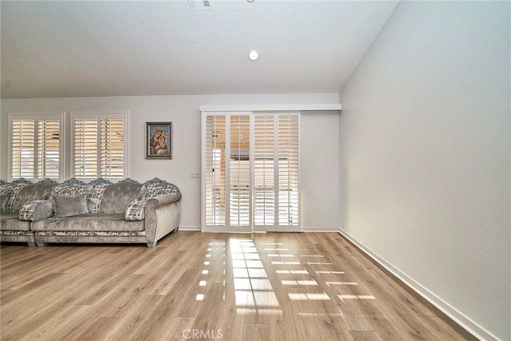7902 Ravello Court Highland, CA 92346 - Photo 13 of 52 a spacious bedroom with a bed and a window