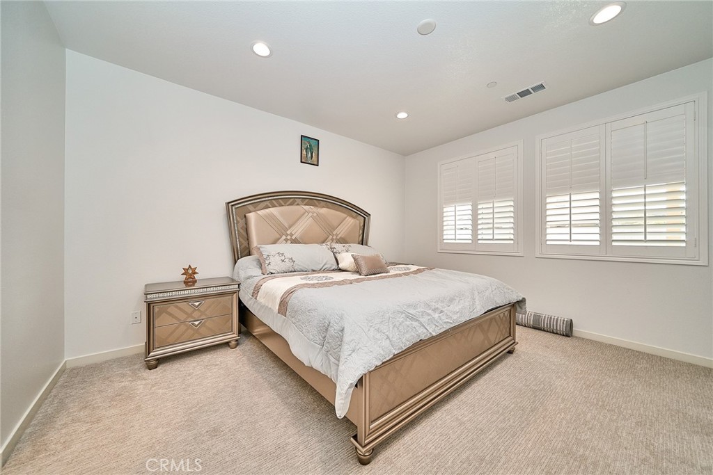 7902 Ravello Court Highland, CA 92346 - Photo 18 of 52 a bedroom with a bed and window