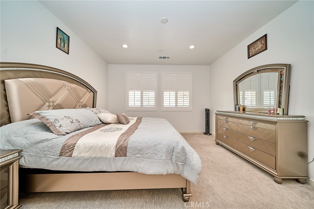 7902 Ravello Court Highland, CA 92346 - Photo 19 of 52 a bedroom with a bed and a dresser in it