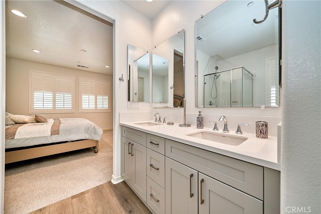 7902 Ravello Court Highland, CA 92346 - Photo 20 of 52 a en suite bathroom with double sink and a mirror