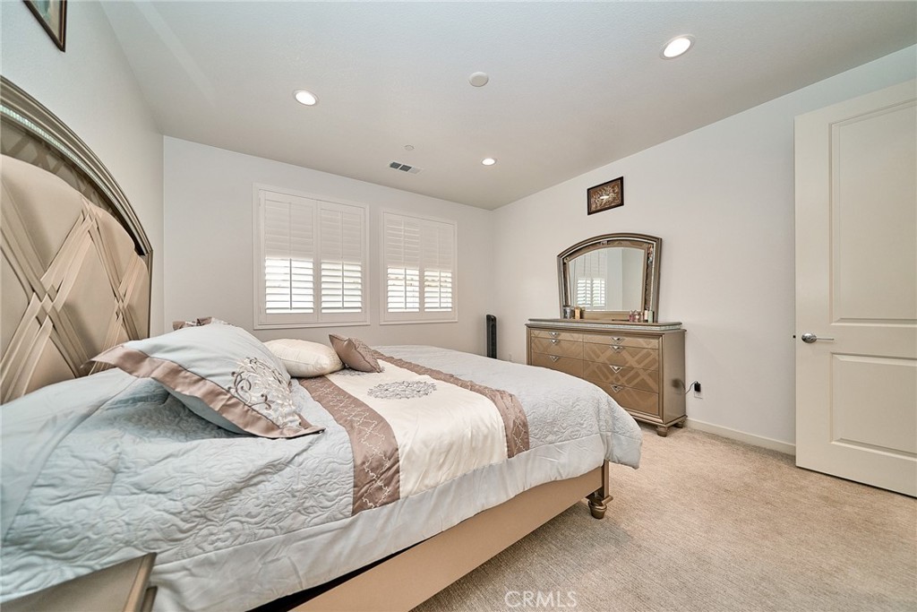 7902 Ravello Court Highland, CA 92346 - Photo 21 of 52 a bedroom with a bed and a large window