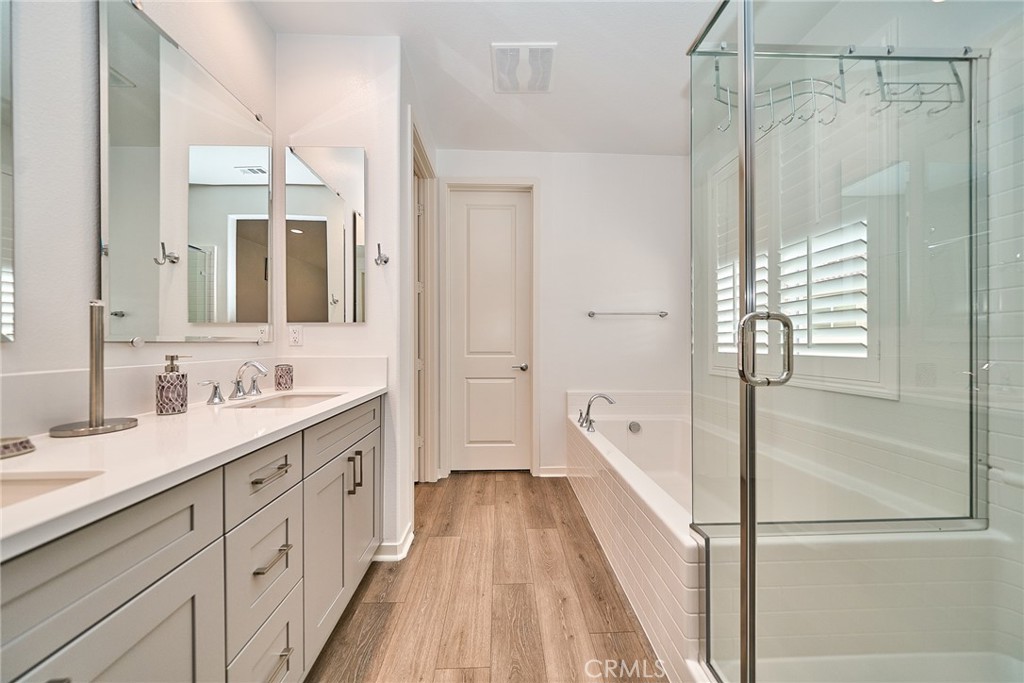 7902 Ravello Court Highland, CA 92346 - Photo 22 of 52 a spacious bathroom with a shower sink and mirror