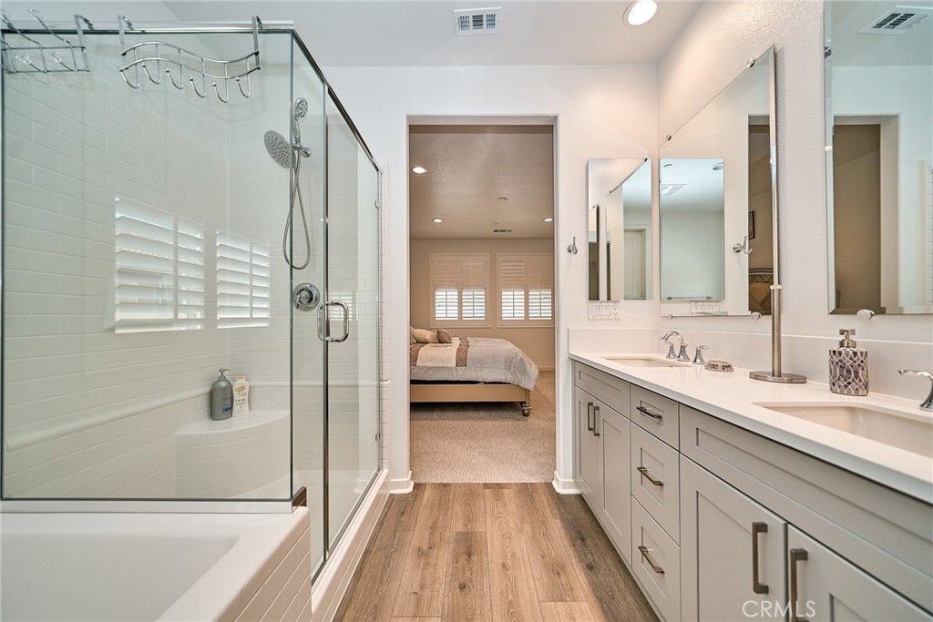 7902 Ravello Court Highland, CA 92346 - Photo 24 of 52 a bathroom with a double vanity sink and mirror with shower