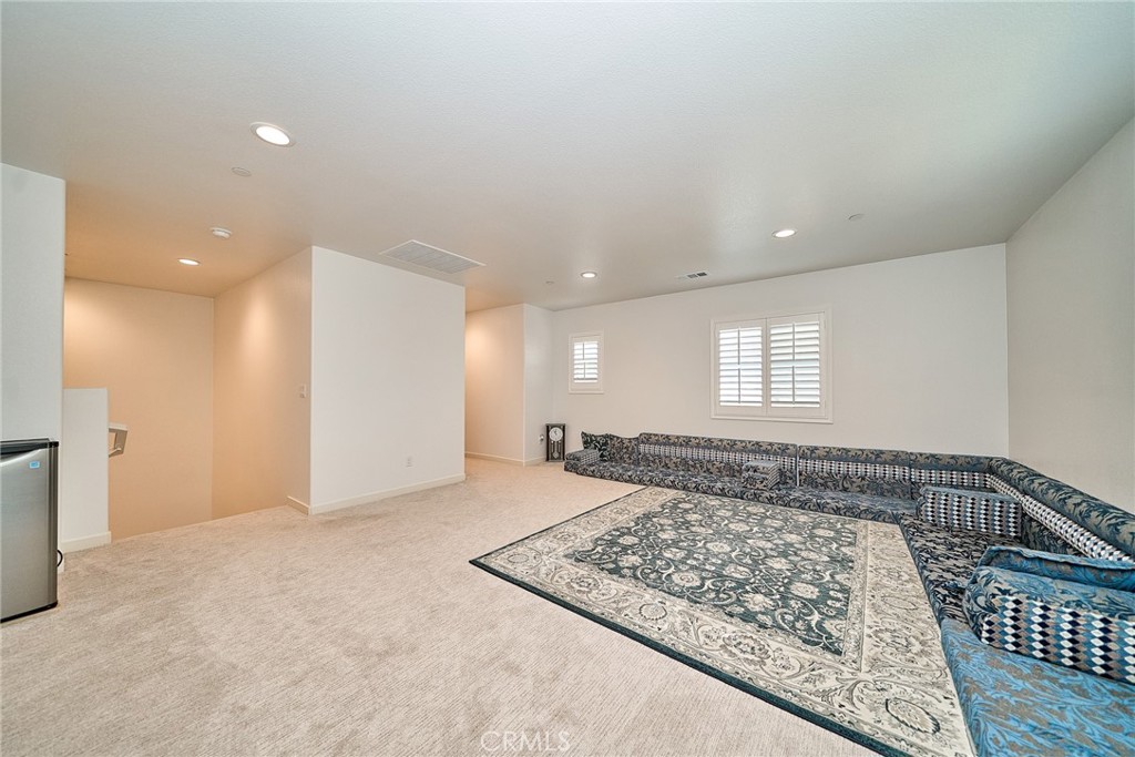 7902 Ravello Court Highland, CA 92346 - Photo 27 of 52 a view of a hallway with a couch and window
