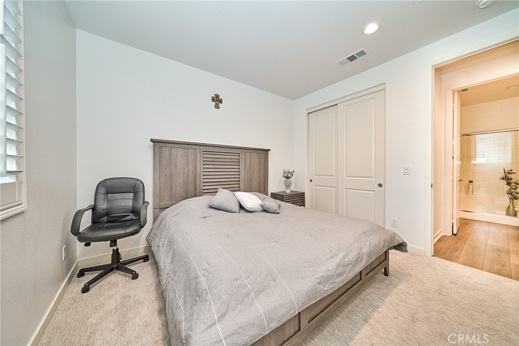 7902 Ravello Court Highland, CA 92346 - Photo 30 of 52 a bedroom with a bed and a desk