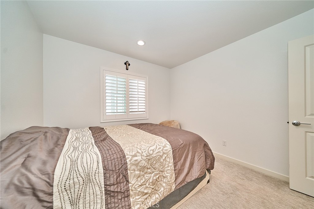 7902 Ravello Court Highland, CA 92346 - Photo 32 of 52 a bedroom with a bed and a window