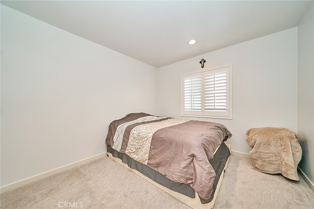 7902 Ravello Court Highland, CA 92346 - Photo 33 of 52 a bedroom with bed and window