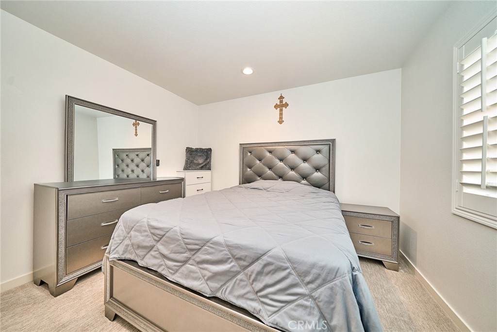 7902 Ravello Court Highland, CA 92346 - Photo 34 of 52 a bedroom with a bed and a window