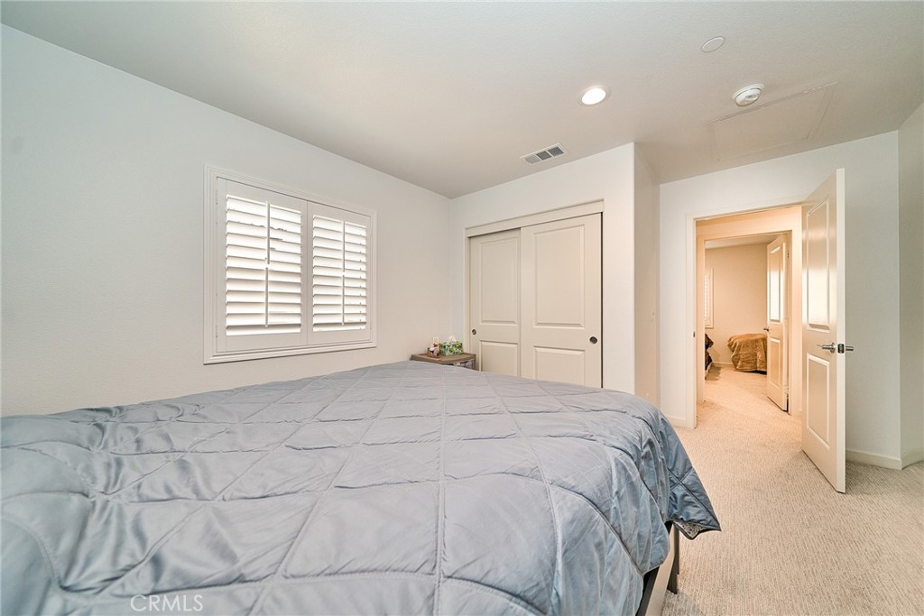 7902 Ravello Court Highland, CA 92346 - Photo 35 of 52 a spacious bedroom with a bed and a window