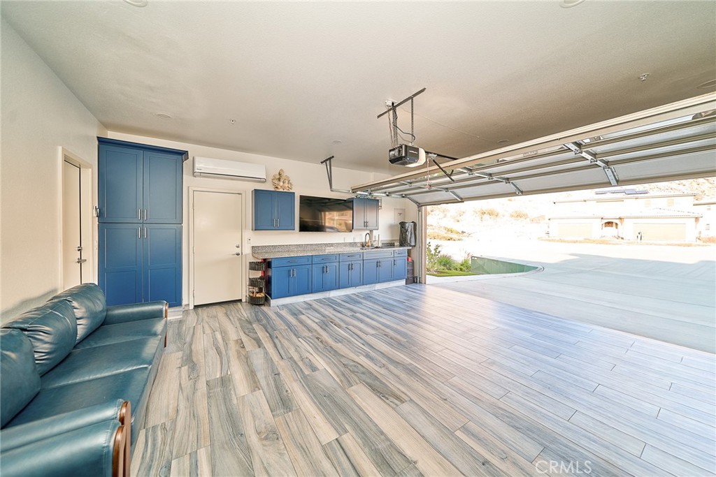 7902 Ravello Court Highland, CA 92346 - Photo 38 of 52 a view of a living room a kitchen with a sink and wooden floor