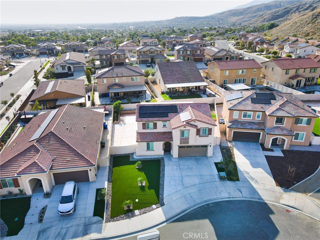 7902 Ravello Court Highland, CA 92346 - Photo 47 of 52 an aerial view of multiple houses with yard