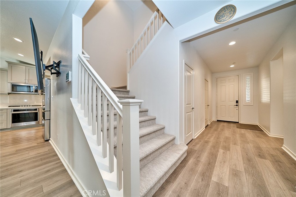 7902 Ravello Court Highland, CA 92346 - Photo 5 of 52 a view of a hallway with wooden floor and staircase