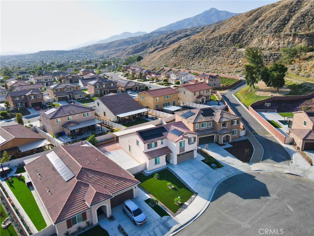 7902 Ravello Court Highland, CA 92346 - Photo 52 of 52 an aerial view of a house with swimming pool and a yard