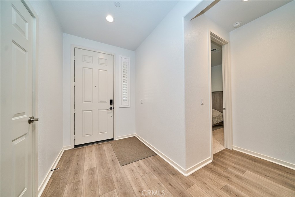 7902 Ravello Court Highland, CA 92346 - Photo 6 of 52 an empty room with wooden floor and closet