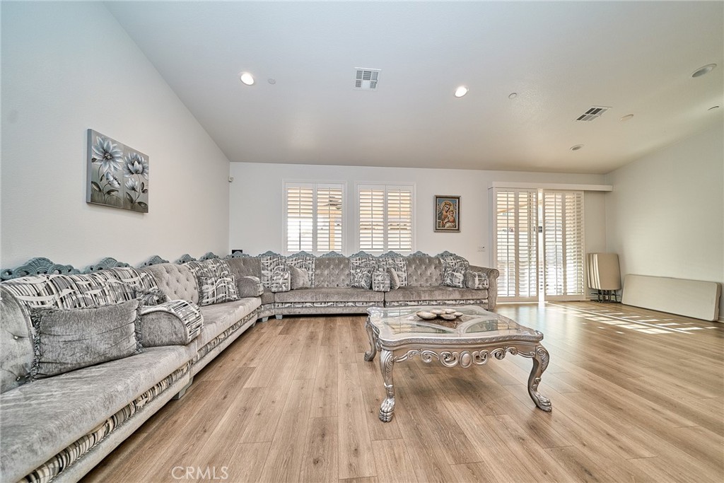 7902 Ravello Court Highland, CA 92346 - Photo 8 of 52 a living room with furniture and a wooden floor