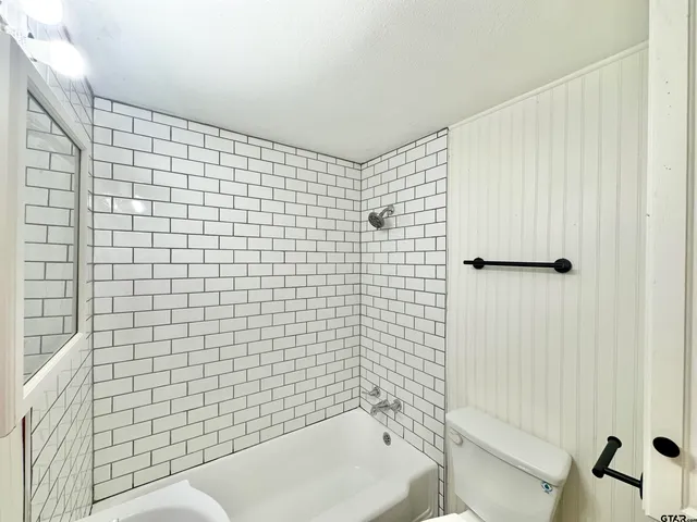 a bathroom with a sink a toilet and bathtub