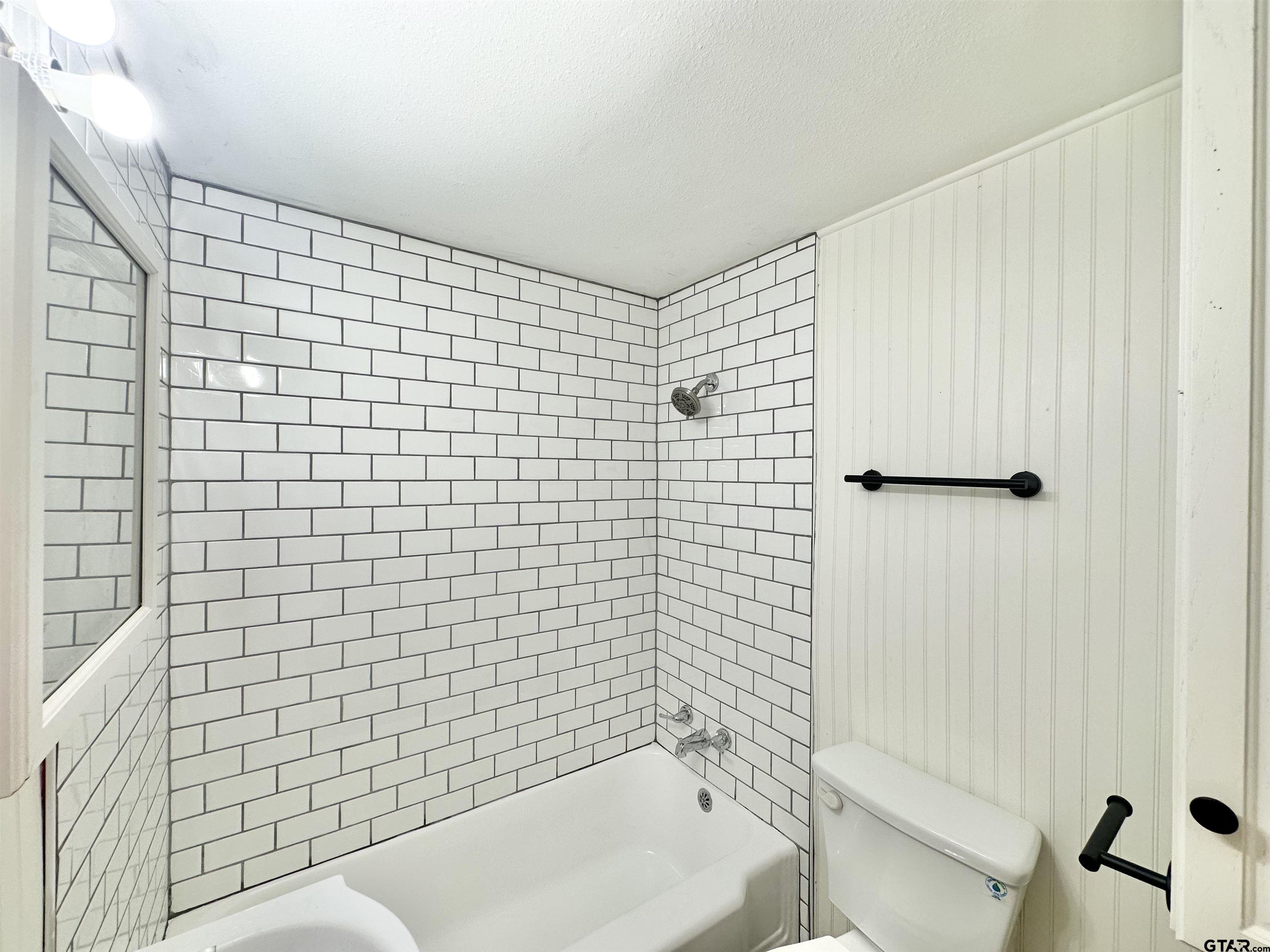 219 Half Street Lindale, TX 75771 - Photo 15 of 33 a bathroom with a bathtub and shower