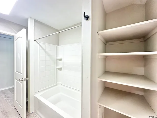a bathroom with a bathtub and a shower