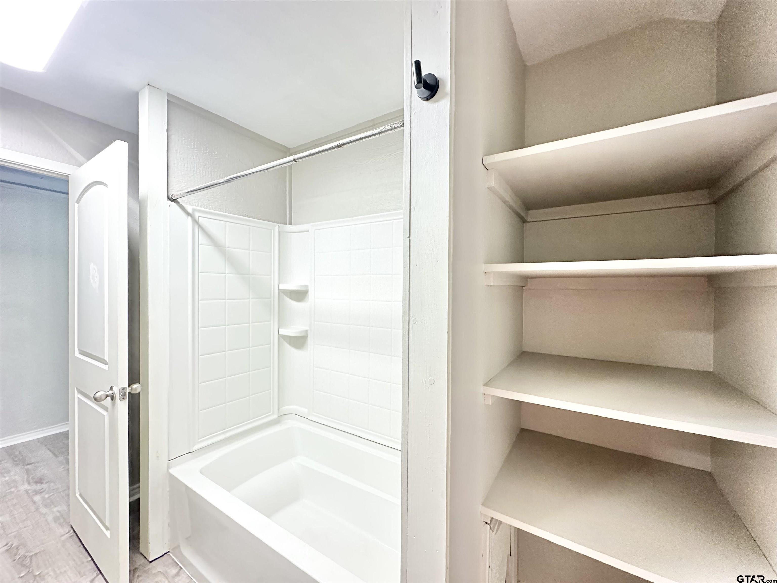 219 Half Street Lindale, TX 75771 - Photo 24 of 33 a bathroom with a bathtub and a shower