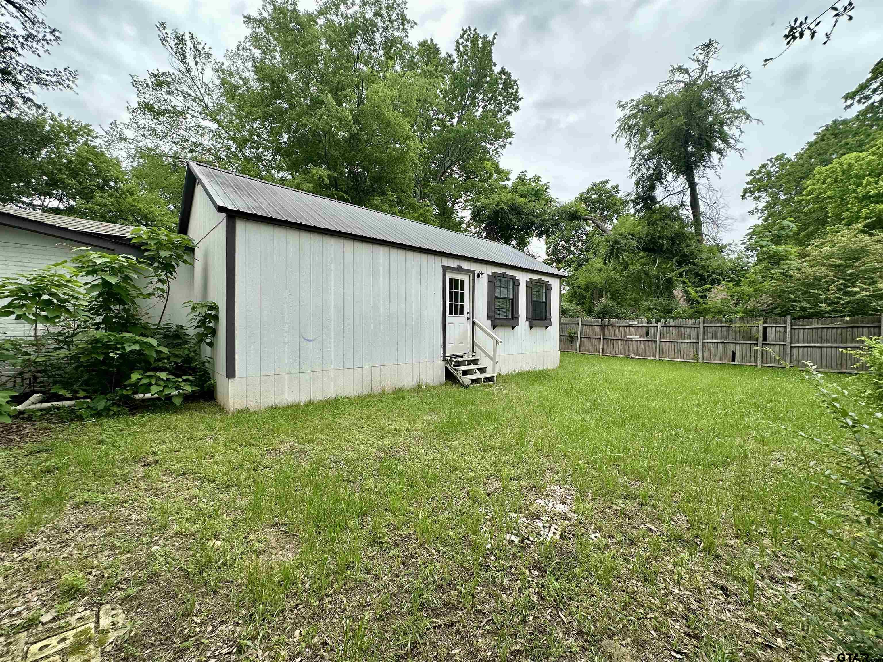 219 Half Street Lindale, TX 75771 - Photo 29 of 33 a backyard of a house with lots of green space