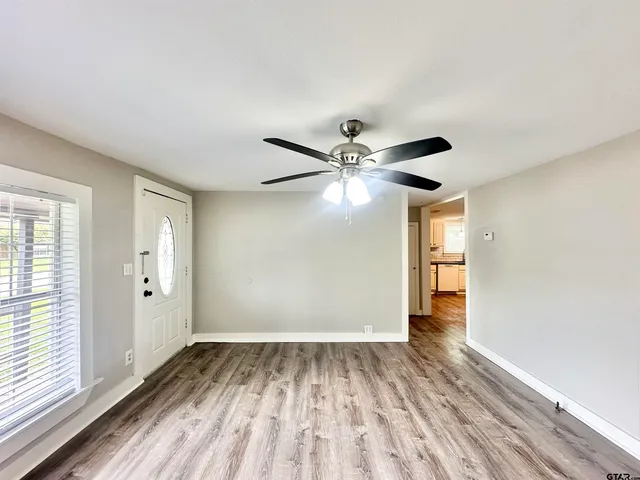 wooden floor in an empty room with a window