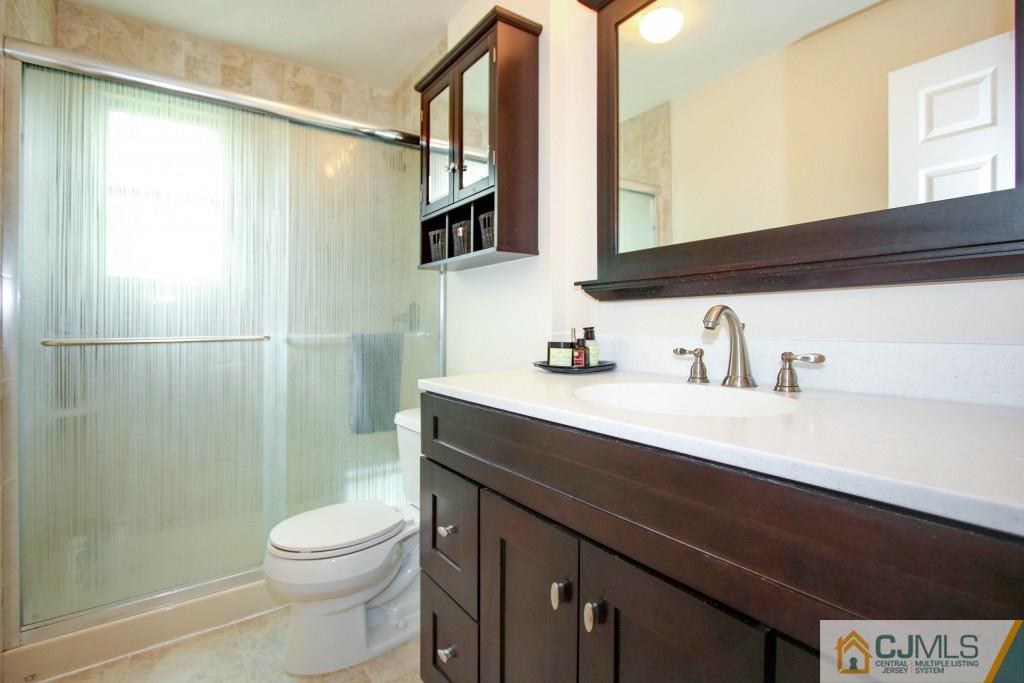 3 Markham Road Edison, NJ 08817 - Photo 17 of 23 a bathroom with a sink a toilet and shower
