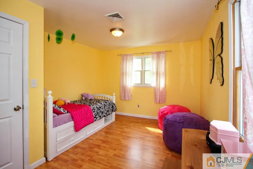 3 Markham Road Edison, NJ 08817 - Photo 18 of 23 a bedroom with a bed and wooden floor