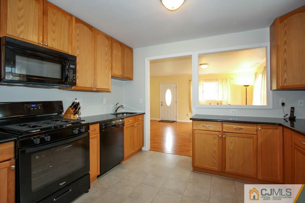 3 Markham Road Edison, NJ 08817 - Photo 9 of 23 a kitchen with stainless steel appliances a stove a sink and a microwave