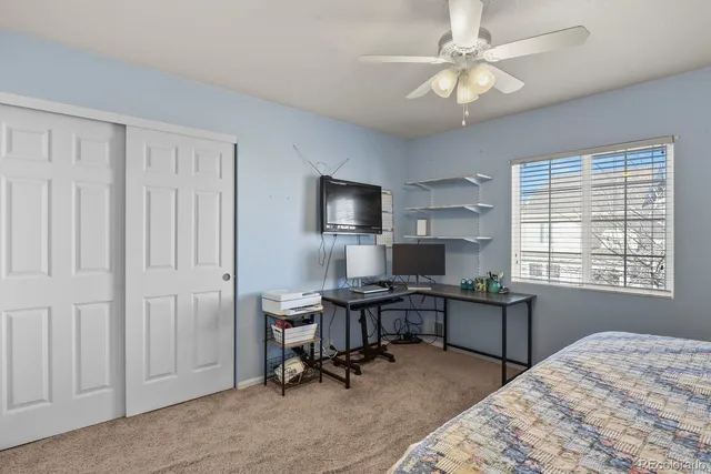 a view of a workspace with furniture and a window
