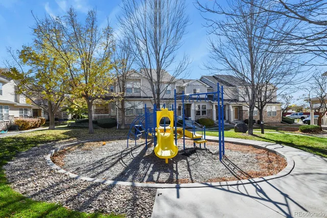 a view of a park with slide and bench