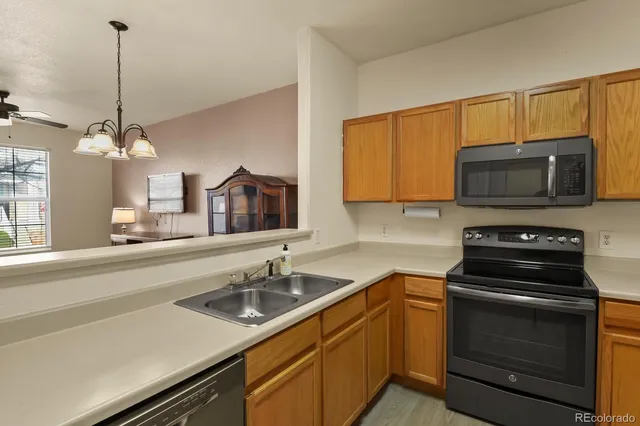 a kitchen with a sink a stove and microwave