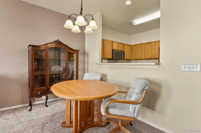 a view of a dining room with furniture and chandelier