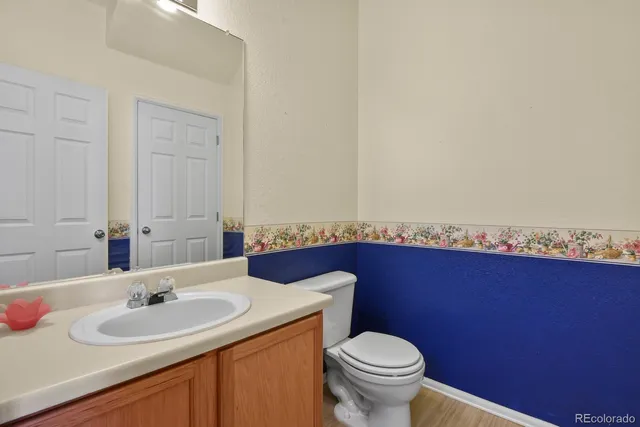 a bathroom with a sink a toilet and mirror