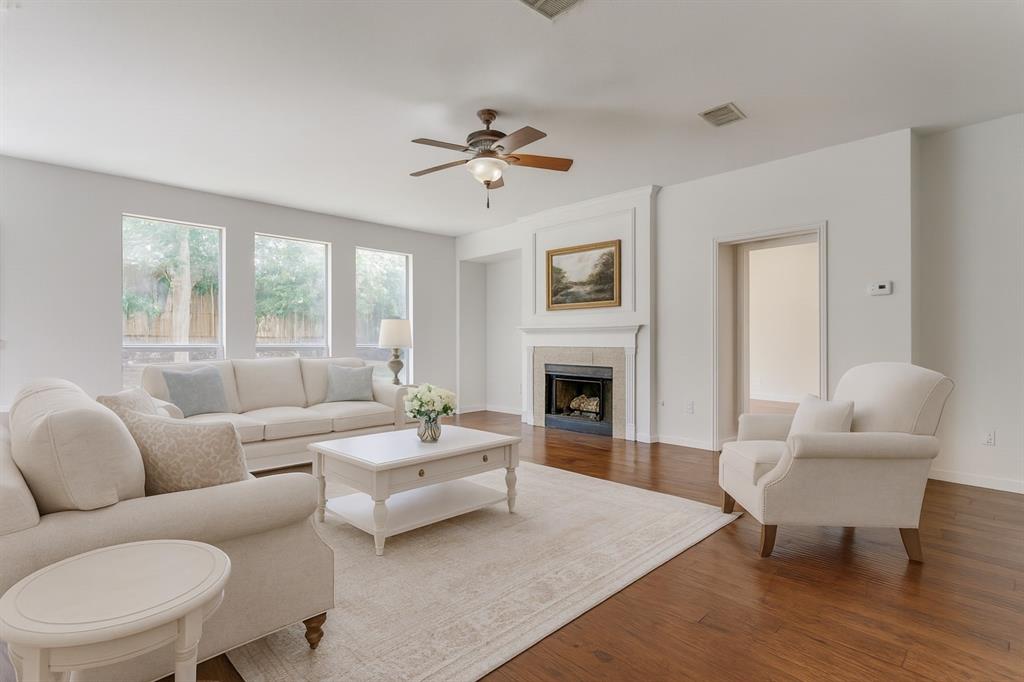 3109 Emory Drive Flower Mound, TX 75022 - Photo 4 of 15 a living room with furniture a fireplace and a table