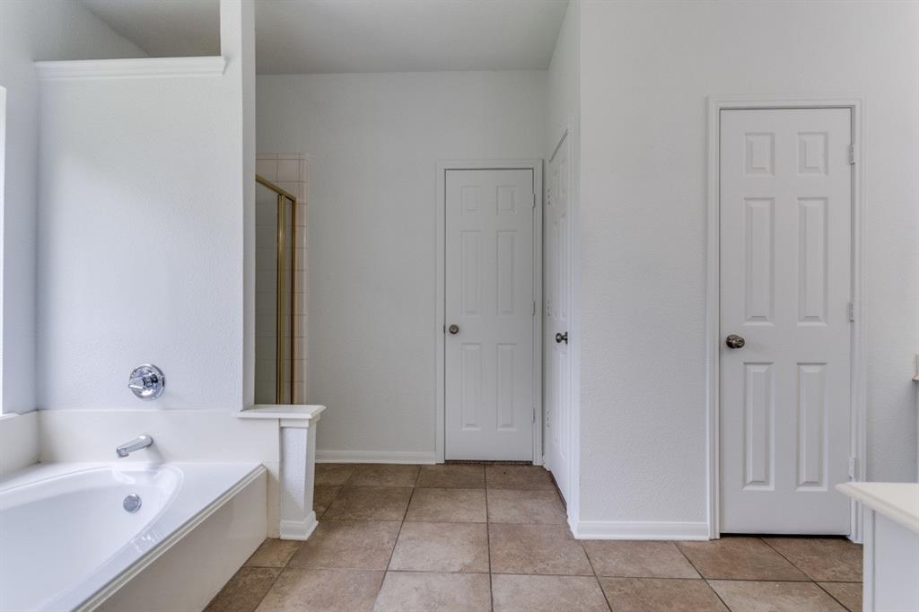 3109 Emory Drive Flower Mound, TX 75022 - Photo 6 of 15 a bathroom with a bathtub and a shower