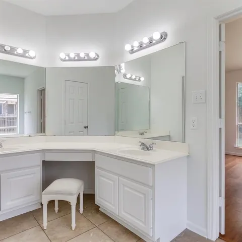 a spacious bathroom with a sink and a mirror