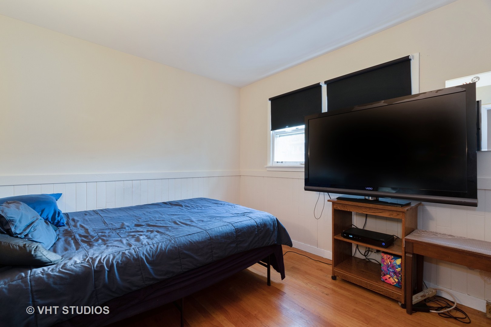 8826 Dee Road Des Plaines, IL 60016 - Photo 13 of 16 a bedroom with a bed and a flat screen tv