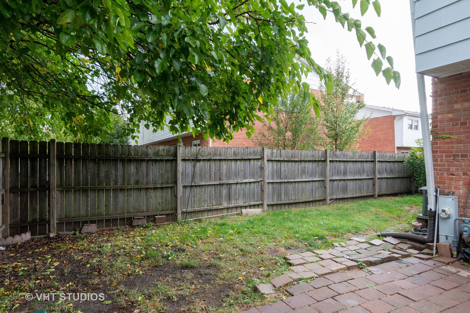 8826 Dee Road Des Plaines, IL 60016 - Photo 3 of 16 a view of a backyard with wooden fence