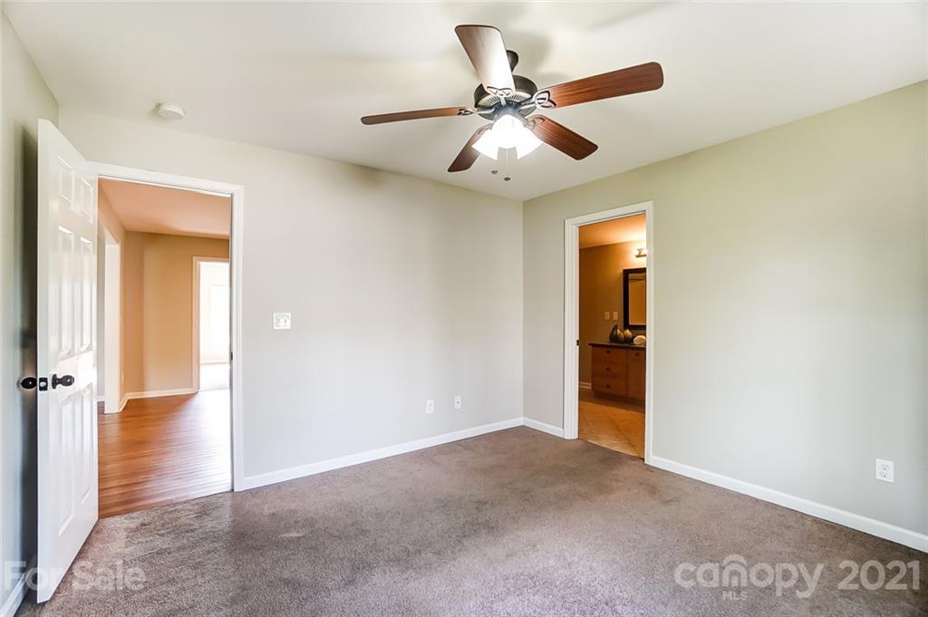 3003 Lowell Road Gastonia, NC 28054 - Photo 11 of 27 wooden floor in an empty room and a fan
