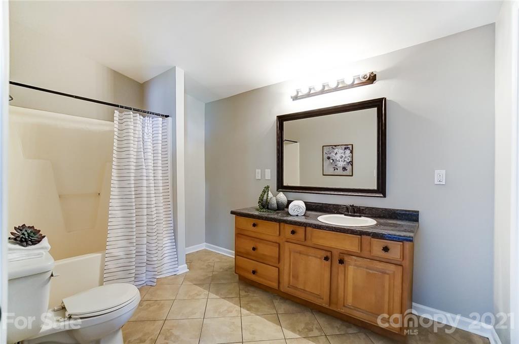 3003 Lowell Road Gastonia, NC 28054 - Photo 13 of 27 a bathroom with a toilet sink and mirror