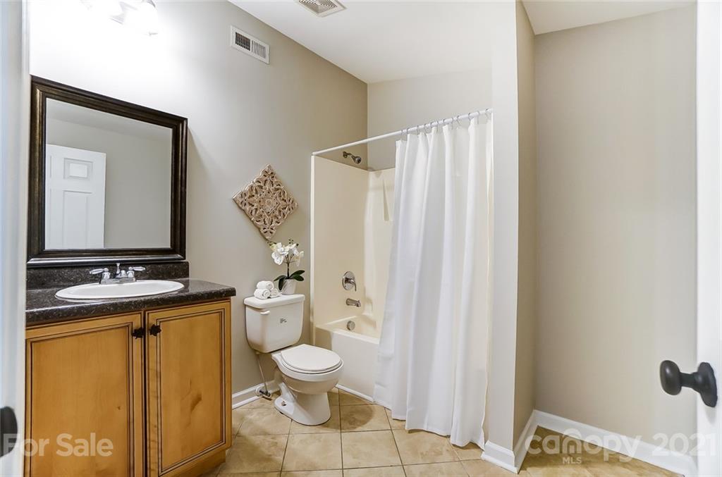 3003 Lowell Road Gastonia, NC 28054 - Photo 22 of 27 a bathroom with a sink a toilet and shower