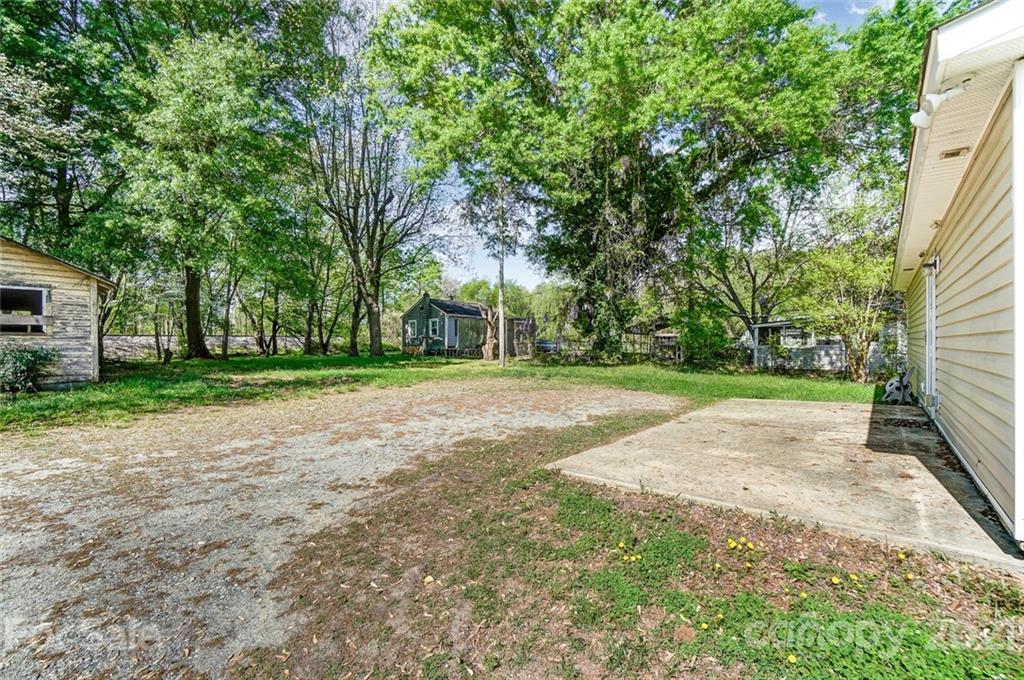 3003 Lowell Road Gastonia, NC 28054 - Photo 27 of 27 a view of a yard with plants and trees