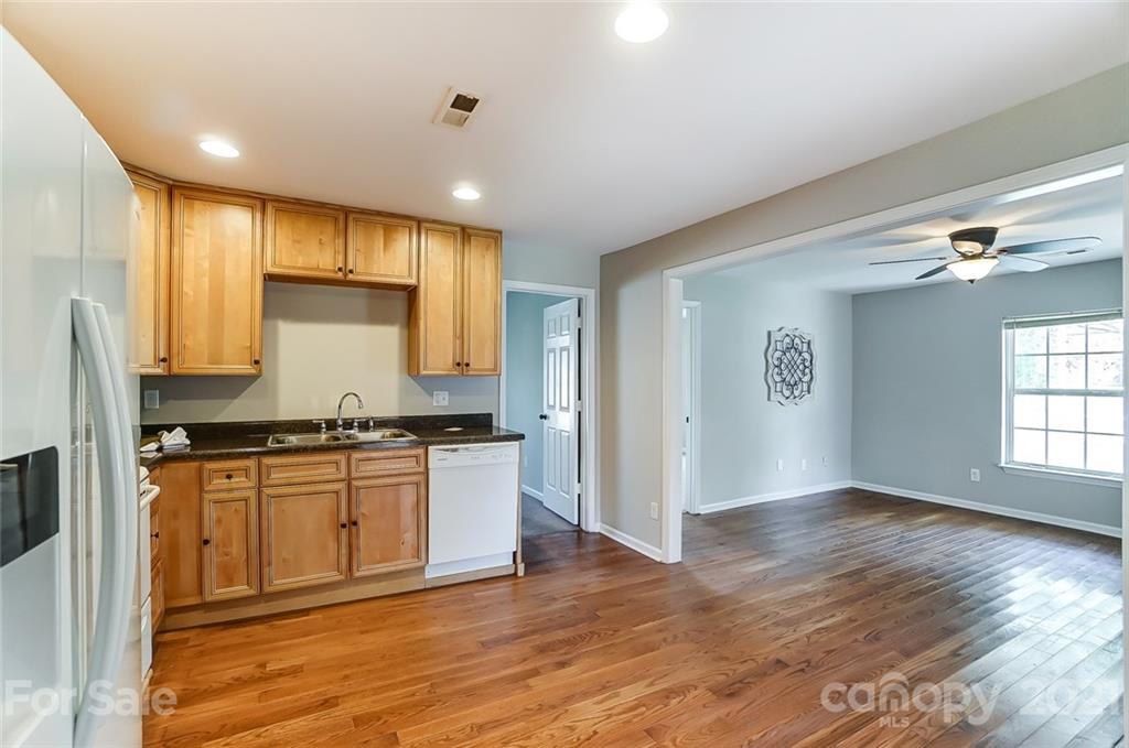 3003 Lowell Road Gastonia, NC 28054 - Photo 5 of 27 a kitchen with stainless steel appliances granite countertop a stove a sink and a refrigerator